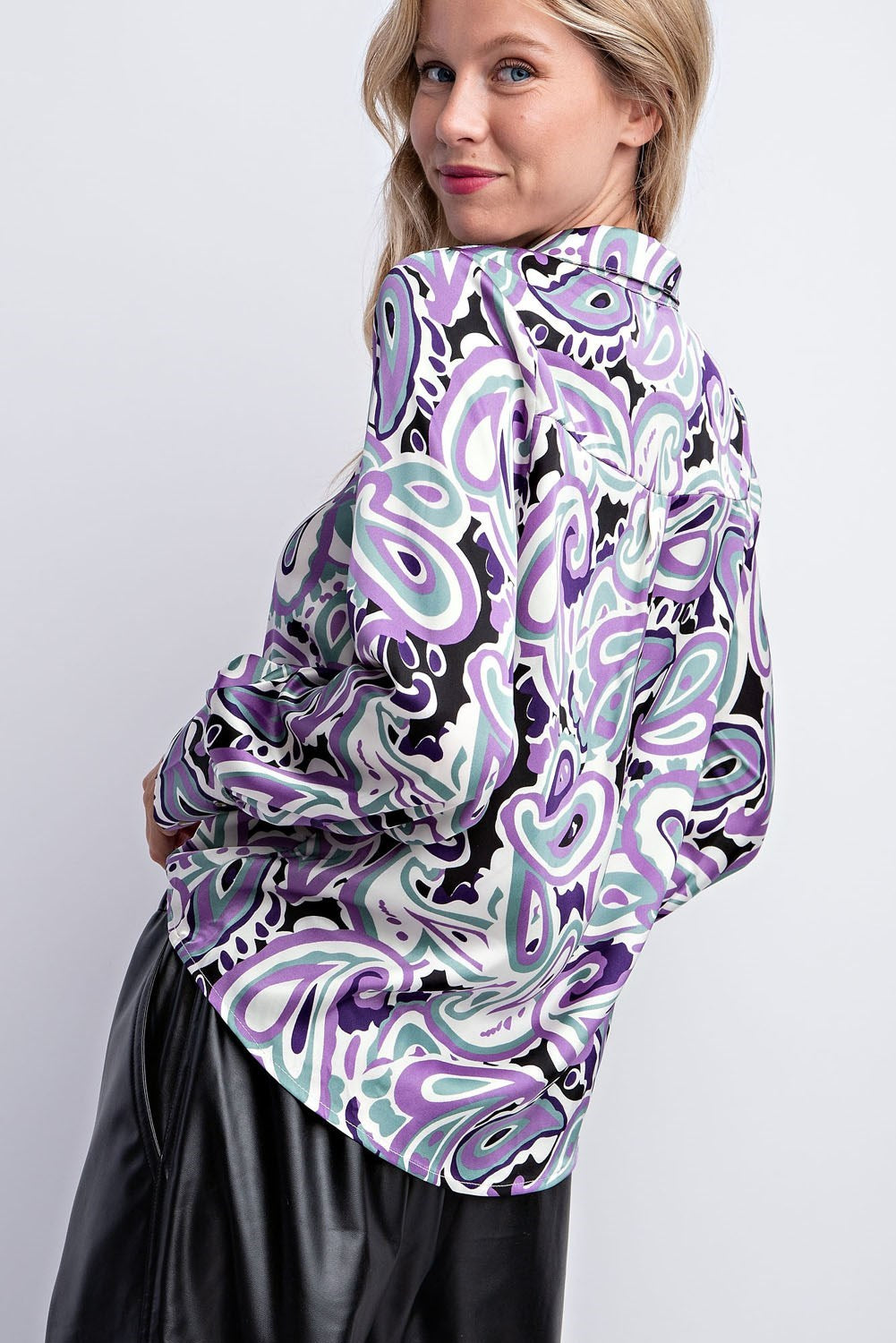 Women’s purple paisley print button-down shirt with intricate pattern and elegant design.