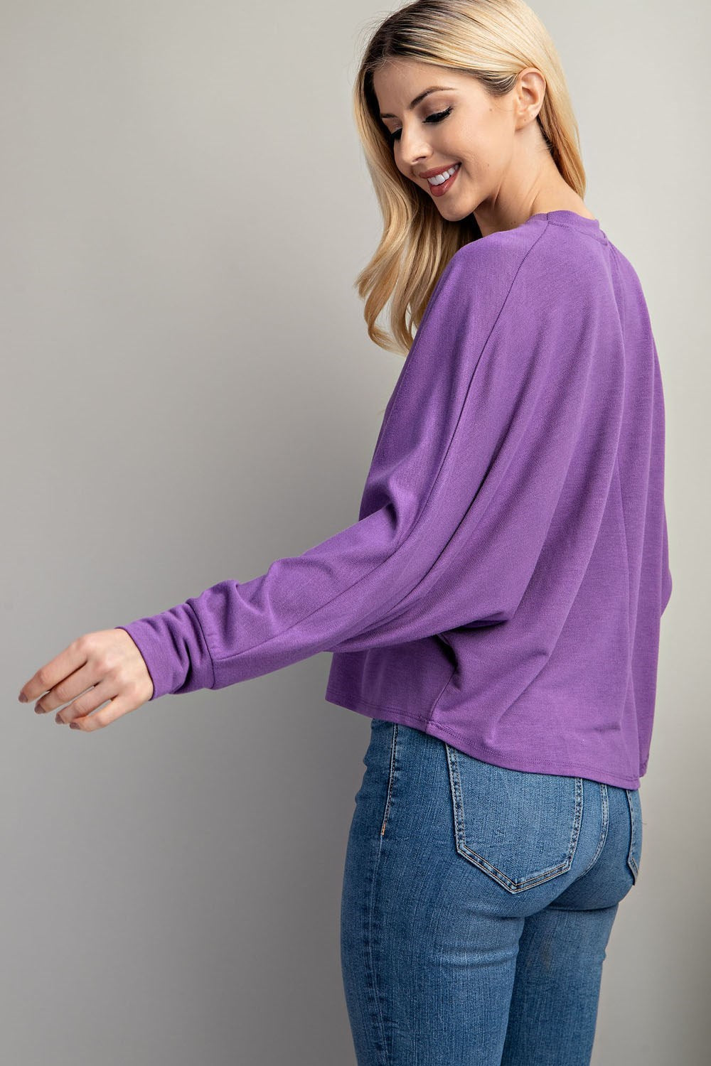 Back view of lavender knit blouse with flattering fit.