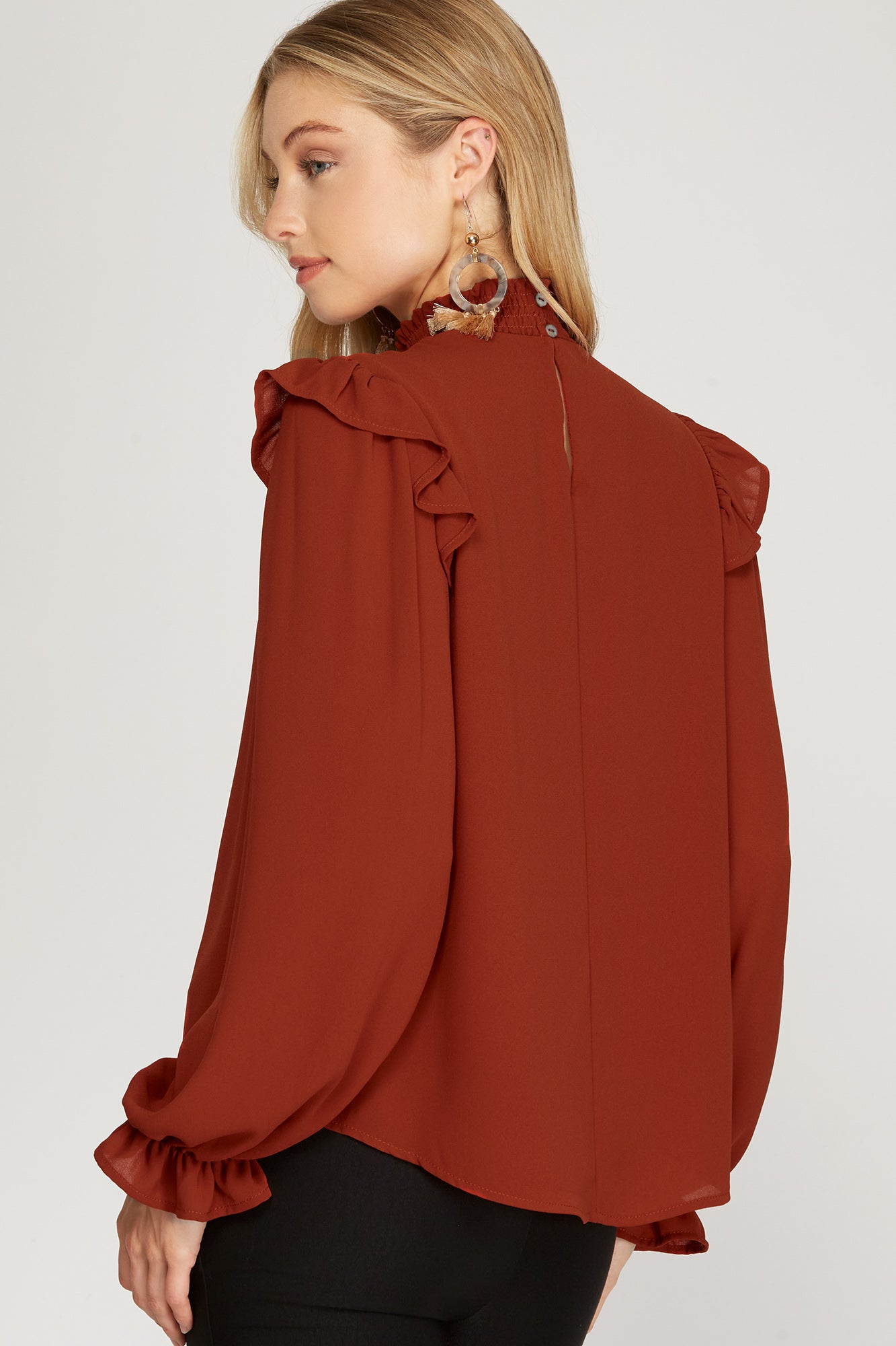 Lightweight woven blouse in rust color.