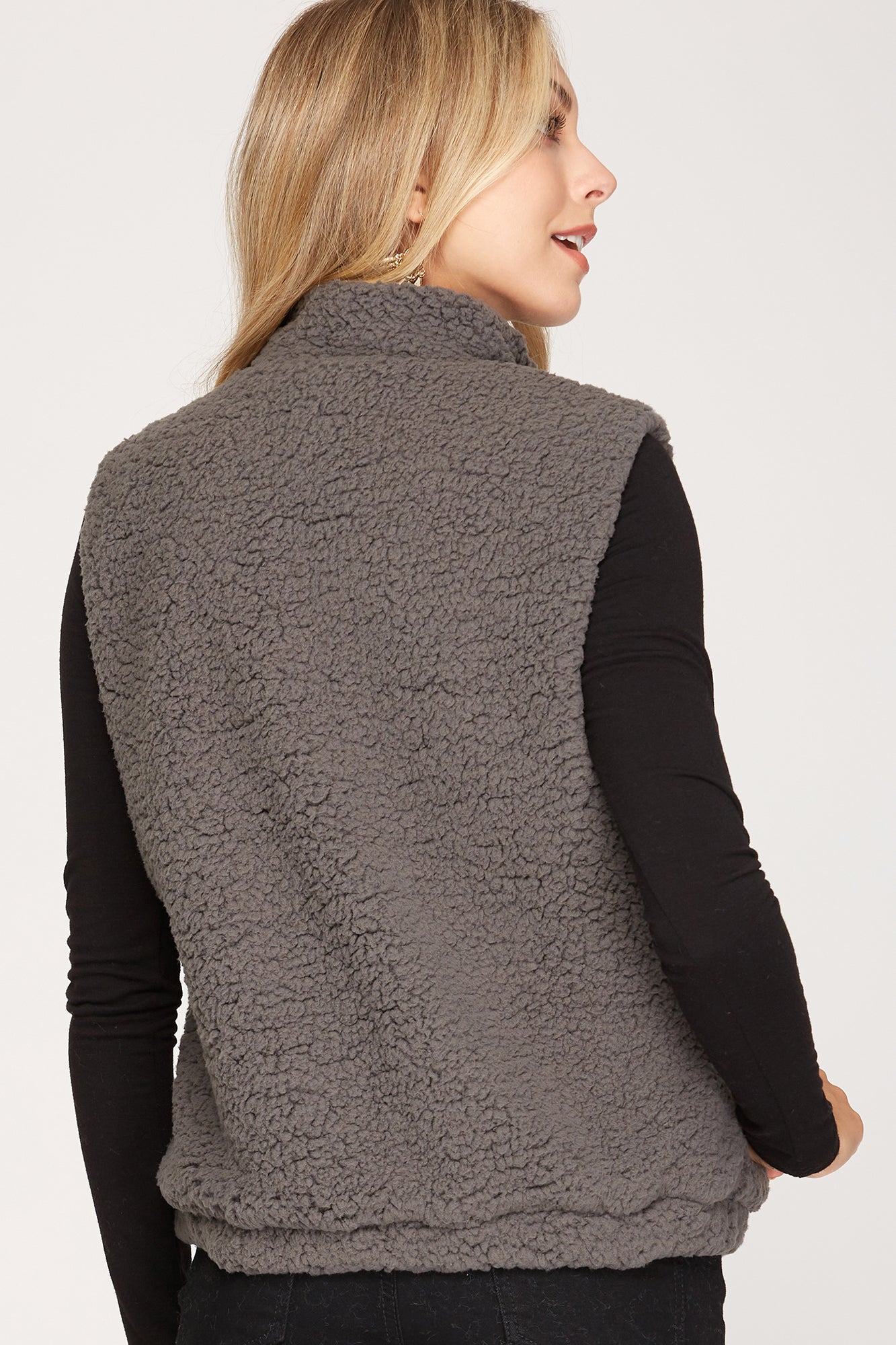 Stylish gray sleeveless vest with soft teddy bear texture and pockets for a chic, cozy look.
