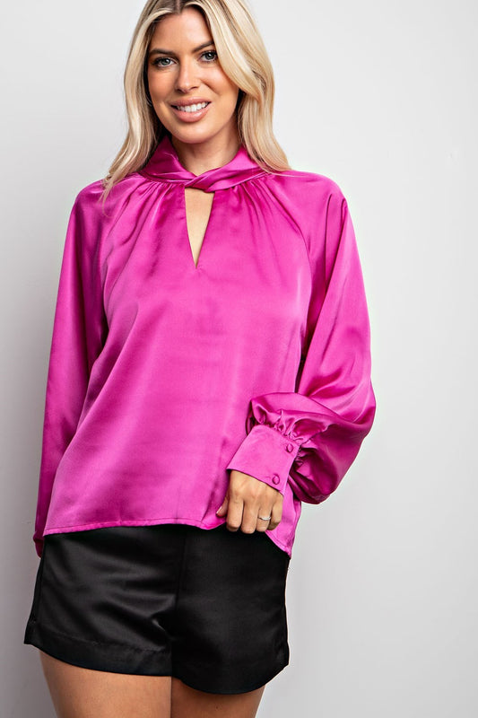 Chic magenta blouse with knotted collar detail.  