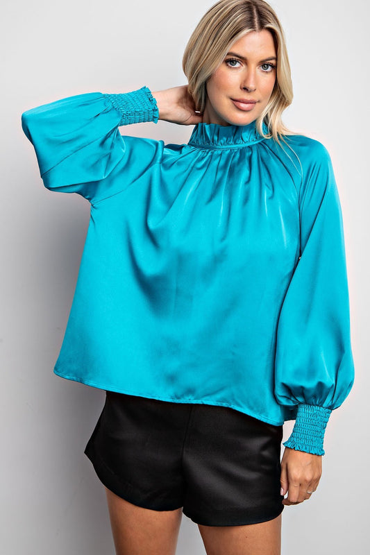 Women’s teal high collar blouse with tie-back detail.  